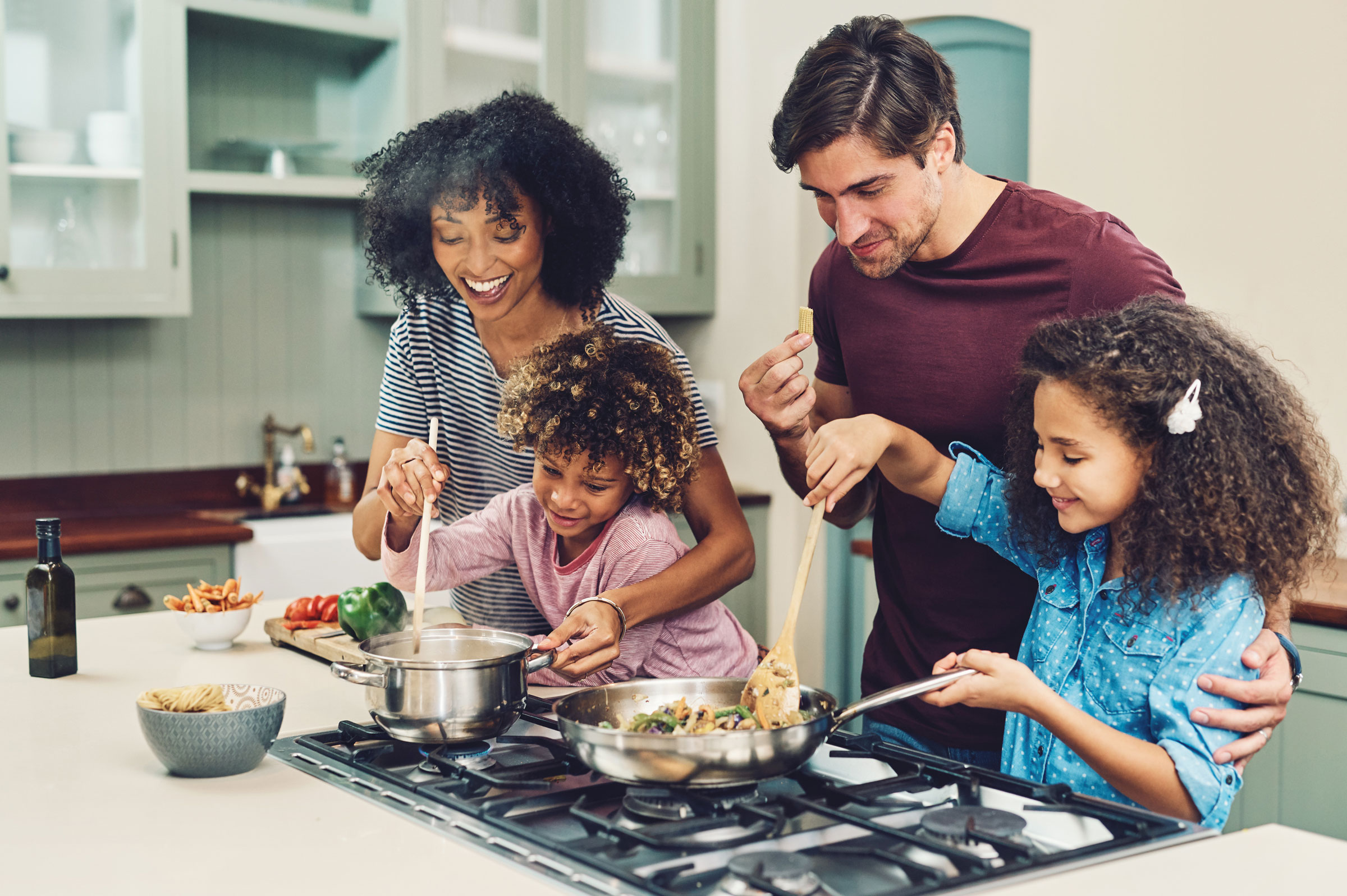 Family cooks a meal together.