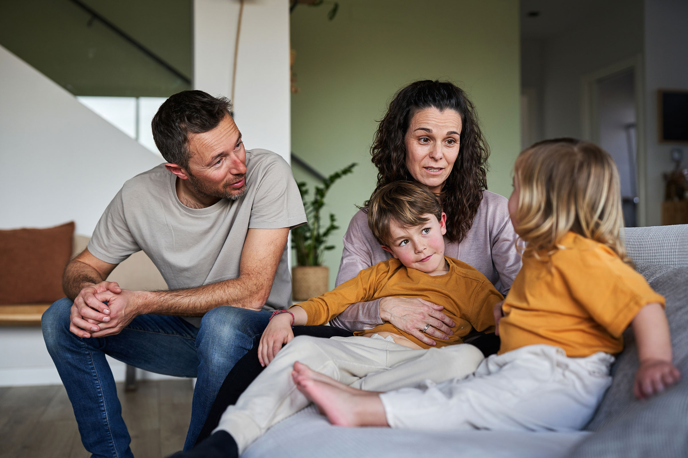Two parents and two kids having a family chat.